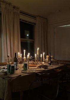 a long table with many bottles and candles on it