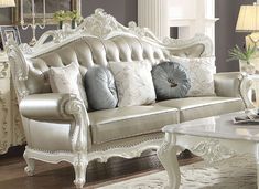 a white couch with pillows on top of it