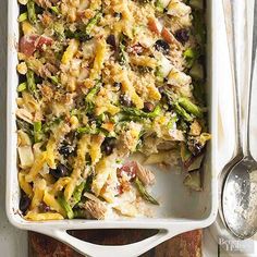 a casserole dish with chicken, asparagus and other vegetables