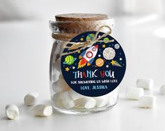 a jar filled with marshmallows on top of a table