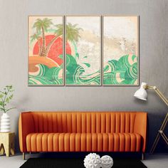 a living room with two paintings on the wall and an orange couch in front of it