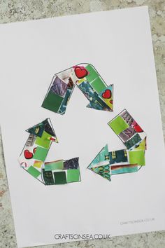 a piece of paper cut into the shape of a recycle