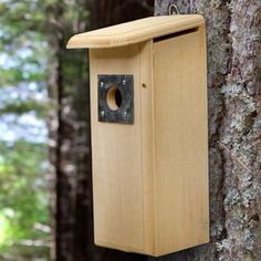 a bird house attached to the side of a tree