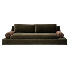 a green couch with two pillows on the back and one pillow on the armrest