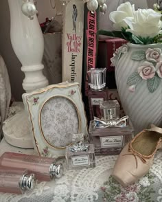 a table topped with vases filled with white flowers and other decorative items next to each other