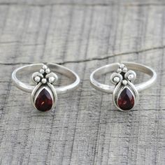 Two garnet teardrops, totaling over one carat, adorn two toe rings from India. Presented by Parul, the colorful pair is handcrafted of sterling silver. Silver Anklets Designs, Toe Ring Designs, Blue Diamond Engagement Ring, Sterling Silver Toe Rings, German Silver Jewelry, Anklet Designs, Silver Jewellery Indian, Silver Toe Rings, Diamond Engagement Ring Set