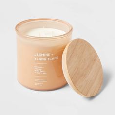 a candle with a wooden lid next to it