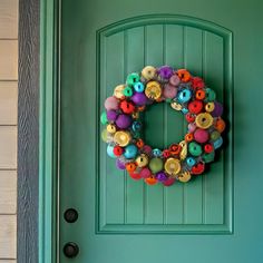 a green door with a colorful wreath on it