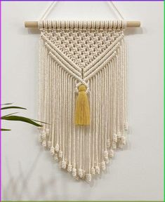 a macrame wall hanging with a tassel