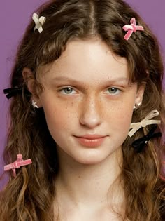 a young woman with long hair and three bows in her hair