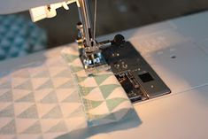 the sewing machine is working on the fabric