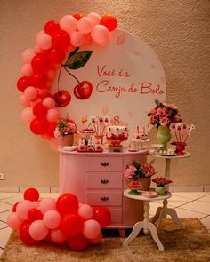 a pink dresser with balloons and decorations on it in front of a sign that says vace la cey de bole