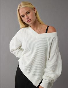 Oversized Casual V-neck Sweater For Loungewear, Trendy Oversized V-neck Sweater For Spring, Trendy Oversized V-neck Sweater For Loungewear, Trendy Relaxed Fit V-neck Sweater, Oversized V-neck Sweater With Ribbed Cuffs For Loungewear, White V-neck Sweater With Ribbed Cuffs, Trendy Oversized White V-neck Sweater, White Ribbed V-neck Sweater, Relaxed V-neck Tops For Fall