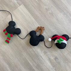 two stuffed animals are laying on the floor with christmas hats and scarves around them