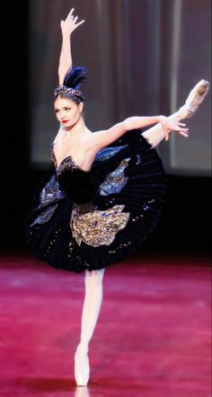 a ballerina is performing on the stage