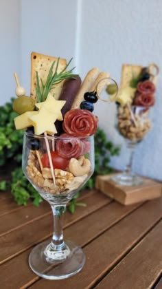 a wine glass filled with different types of food