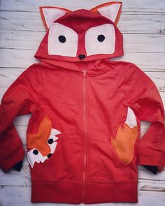 This fox hoodie has been a huge hit. Perfect for any fox lover . I recently took our fox pocket hoodie and this hoodie and combined them. You can choose if you want a fix in the pocket or not. Orange hoodie may vary in different shades. Each computer / screen / phone might show colors differently. Orange hoodies are a tough find so that is why sometimes I have to use different brands and they have a slight color difference. Wash inside out and lay or hang to dry. If dried in the dryer they loose Cute Hooded Cotton Sweater, Cute Winter Tops With Pockets, Playful Hooded Fleece Sweatshirt, Playful Fleece Hoodie With Long Sleeves, Playful Long Sleeve Fleece Hoodie, Playful Red Sweatshirt For Fall, Cute Fall Hoodie Sweater, Playful Hooded Winter Hoodie, Playful Winter Hooded Hoodie