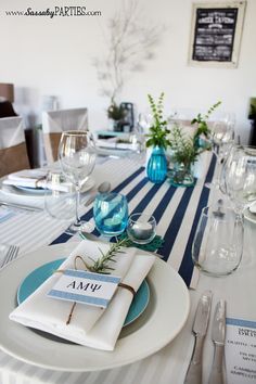 the table is set with blue and white place settings