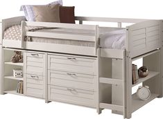 a bunk bed with drawers underneath it and a pillow on the bottom shelf above it