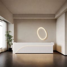 an empty room with a white reception counter and potted plant in the corner on the wall