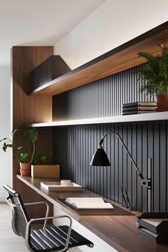 an office with wooden shelves and desks, bookshelves and plants on the wall