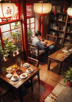 a person sitting at a table with plates of food in front of them and plants