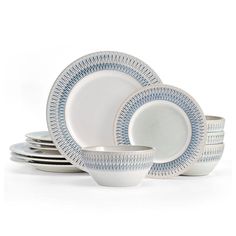 a white and blue dinner set on a white background with place settings in the middle