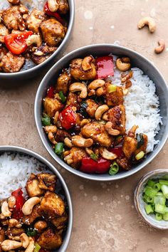 three bowls filled with rice and chicken on top of a table next to cashews