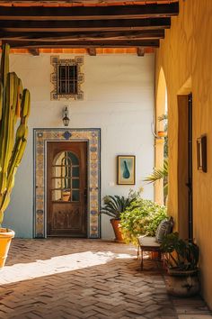 the entrance to a house with potted cacti