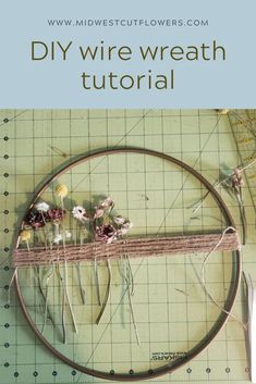 a circular frame with flowers on it and text overlay that reads diy wire wreath