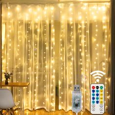 a remote control sitting on top of a wooden floor next to a window covered in lights