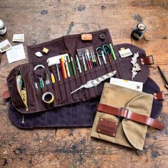 an assortment of crafting supplies laid out on top of a wooden table next to scissors and other items