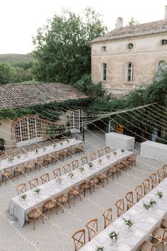 an outdoor venue with tables and chairs set up for a wedding reception in the countryside