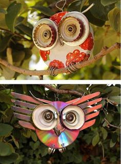 an owl ornament hanging from a tree branch