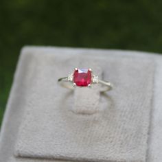 * Material: 925 Sterling Silver * DETAILS ✥ Handmade Ring ✥ - Center Stone: Lab Ruby - Center Stone Size: 6 MM - Center Stone Shape: Cushion  - Side Stone: CZ Diamond  ✥ O T H E R ∙ I N F O R M A T I ON ✥ ♦ Your item will be nicely packed to gift in elegant jewelry boxes. ♦ Custom Order We can make custom rings in almost any shape and style. If you want a specific model, please send us a clear picture and we will do our best. ♦ Delivery All Item will be Shipped within 3 to 5 Days after payment receive. The delivery time usually takes 11 to 23 days, depending which Country & location. ♦ Payment we accept payment through PayPal only, Payment should be made within 3 days of purchase. ♦ Ring Size Visit your local jeweller to be sized, (Most offer this service for free). I can make this ring in Cushion Cut Wedding Rings, Red Gems, Wedding Ring Cushion, Silver Ring Wedding, July Birthstone Ring, Wedding Anniversary Ring, Ring Cushion, Wedding Anniversary Rings, July Birthstone