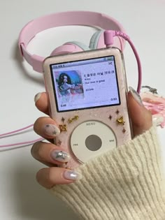 a person holding an ipod in their hand