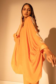 Rust orange pure chiffon draped top with resham, sequins and cutdana embroidered sleeves. Comes with straight pant.
Components: 2
Pattern: Embroidered
Type Of Work: Resham, Sequins, Cutdana
Neckline: V Neck
Sleeve Type: Draped Sleeves
Fabric: Pure chiffon
Color: Orange
Other Details: 
Attached lining
Occasion: Work - Aza Fashions Orange Traditional Drape Blouse For Navratri, Orange Bollywood Blouse With Traditional Drape, Chiffon Blouse With Sheer Dupatta In Traditional Drape, Orange Bollywood Blouse Piece For Party, Orange Georgette Blouse Piece For Navratri, Bollywood Style Orange Blouse With Traditional Drape, Orange Party Blouse With Traditional Drape, Georgette Party Tops For Eid, Party Wear Draped Blouse With Sheer Dupatta