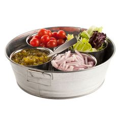 a metal bowl filled with different types of food