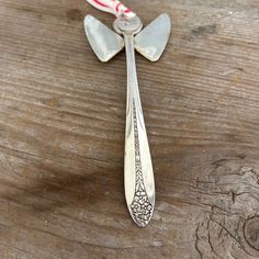 a spoon that is sitting on top of a wooden table with candy canes in it