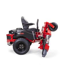 a red riding mower sitting on top of a white floor next to a black seat