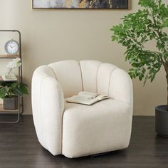 a white chair sitting next to a potted plant