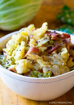 a white bowl filled with food on top of a wooden table