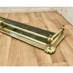 a gold and black bench sitting on top of a hard wood floor