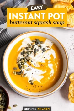 a bowl of butternut squash soup with toasted pumpkins and seeds on the side