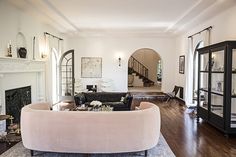 a living room filled with furniture and a fire place in the middle of a room