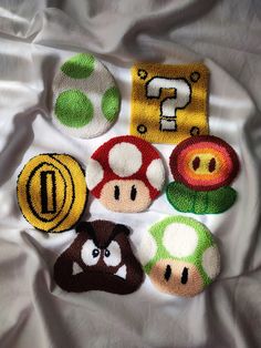 several different types of knitted objects on a white cloth background with question mark in the middle