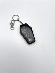 Soooky items and some glitter fill up this cute little black coffin shaker Keychain.  Can be made into a charm with attachment pictured just message you want a charm instead of keychain. Handmade so they will be different includes shaker contents.  Can be made in other colors just send me a message. Goth Keychains, Coffin Keychain, Halloween Keychain, Shaker Keychain, Goth Kawaii, Merch Design, Kawaii Goth, Keychain Handmade, Keychain Charm