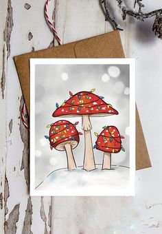 a card with two mushrooms on top of it, one is red and the other is green