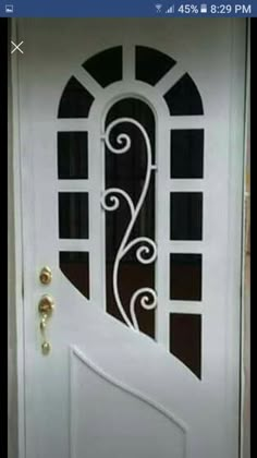 a white door with an iron design on it