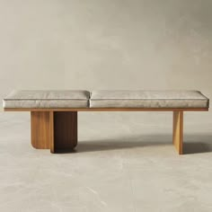 the bench is made from wood and has two cushiones on each side, along with an upholstered seat